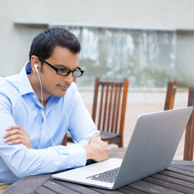 stock-photo-closeup-portrait-young-man-in-blue-shirt-and-black-glasses-listening-to-headphones-browsing-197245688 stock-photo-closeup-portrait-young-man-in-blue-shirt-and-black-glasses-listening-to-headphones-browsing-197245688